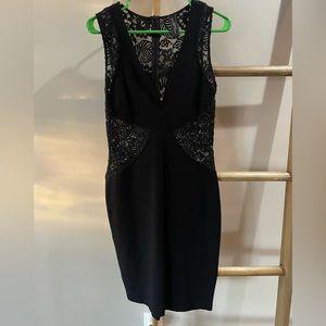 Little black dress with lace cutouts.